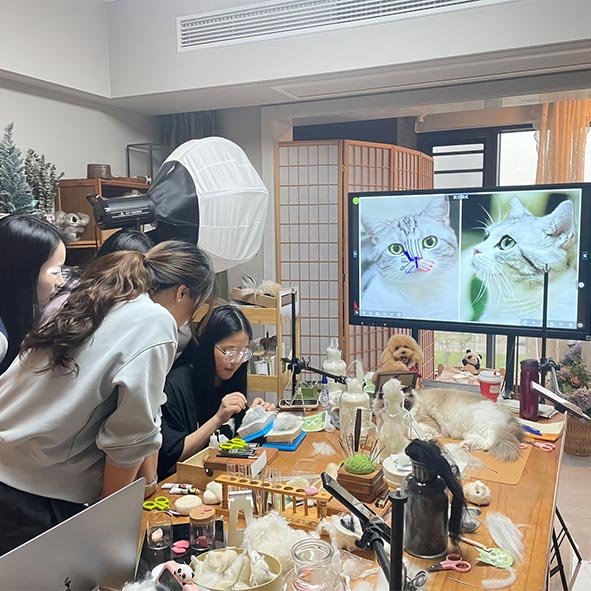 Custom pet art studio workspace with artists crafting acrylic portraits, felt sculptures, and pet memorial keepsakes after deposit confirmation