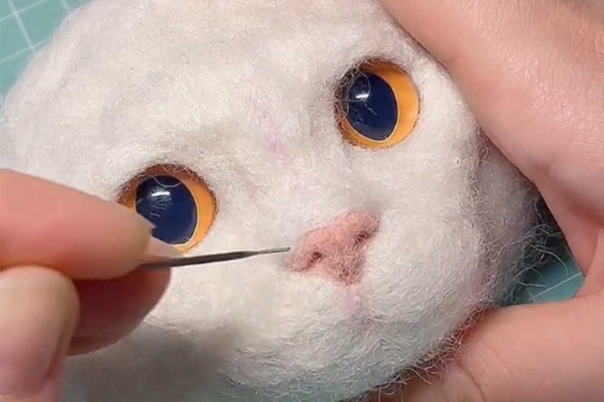 Professional artist crafting a custom needle felted pet sculpture using premium wool to capture a realistic and soulful pet portrait