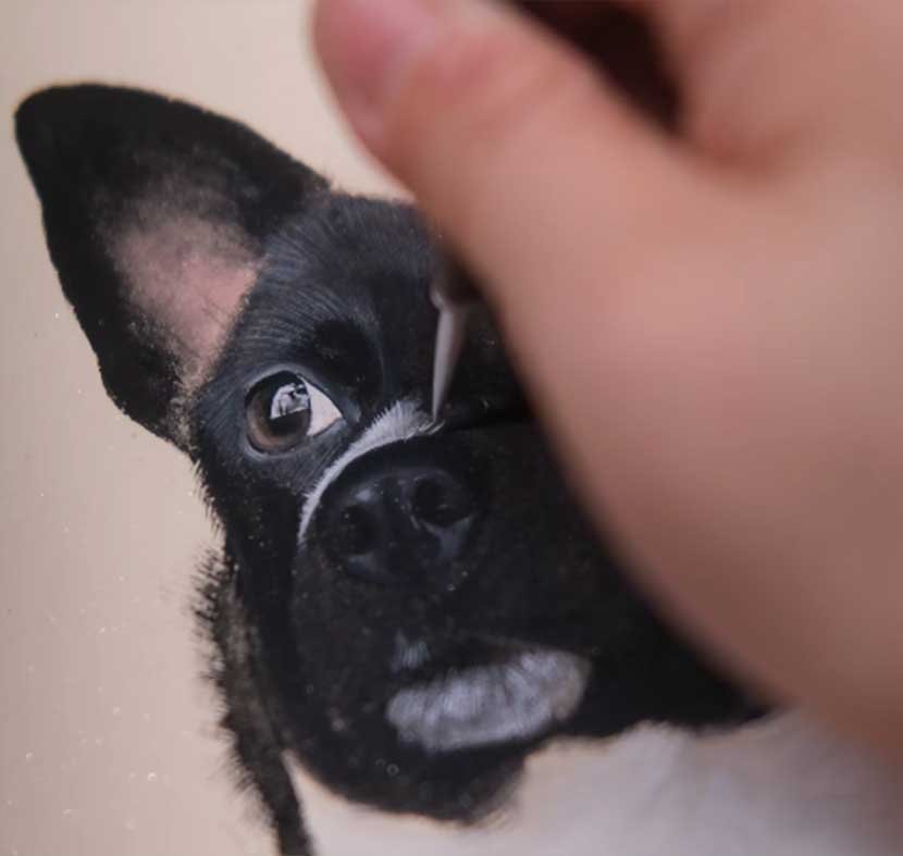 Close-up of a hand-painted dog portrait showing the fine brushstrokes and layers of pigment used to capture a pet's soul.