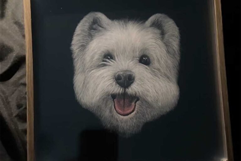 Finished 3D custom pet portrait of a smiling white dog in a wooden frame, a responsive artwork that changes expression with light.