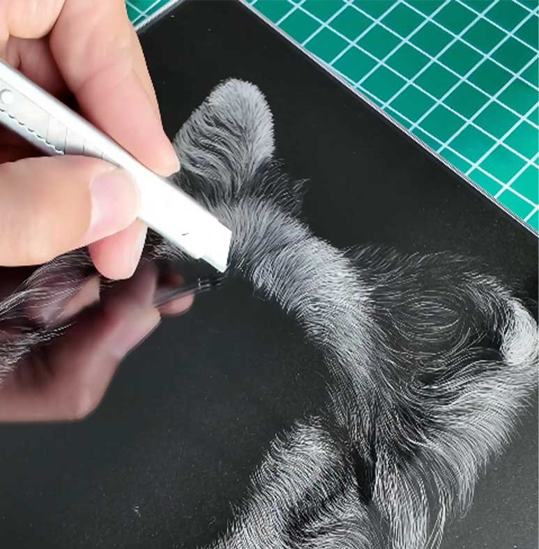 Close-up of handmade 3D pet portrait engraving process on acrylic sheet, showing detailed fur texture and craftsmanship.