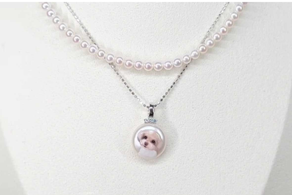 High-end custom pet necklace set featuring a hand-painted dog portrait pendant on a pearl and a matching pearl choker.