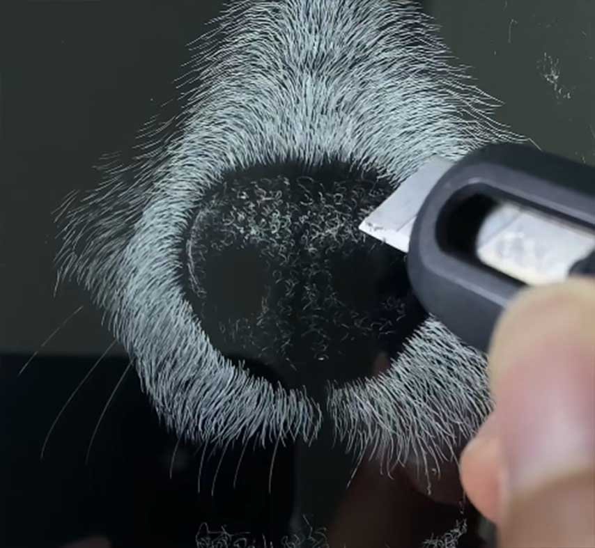 Close-up of hand-engraved 3D pet portrait on acrylic, showing intricate nose texture and fine fur details for custom pet memorial gifts.
